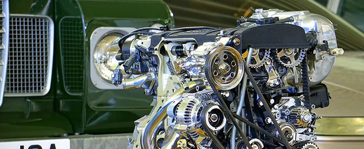 Close up shot of an engine infront of a car