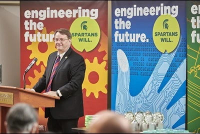 Engineering Dean Leo Kempel presenting with engineering banners in the background. 