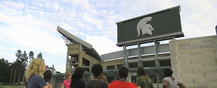 A group of people viewing the spartan stadium