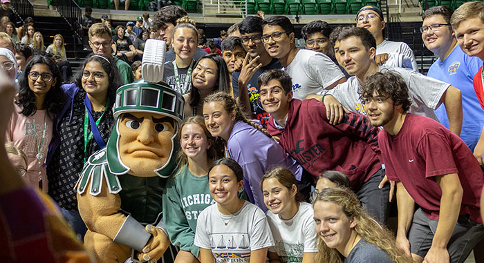 First-year Engineering students attending Colloquium and huddling around Sparty