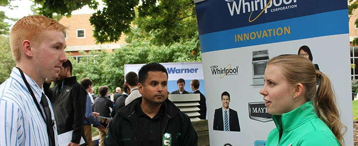 Student talking to Whirlpool representative at a career fair