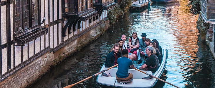 People in a boat going down a canal in Italy