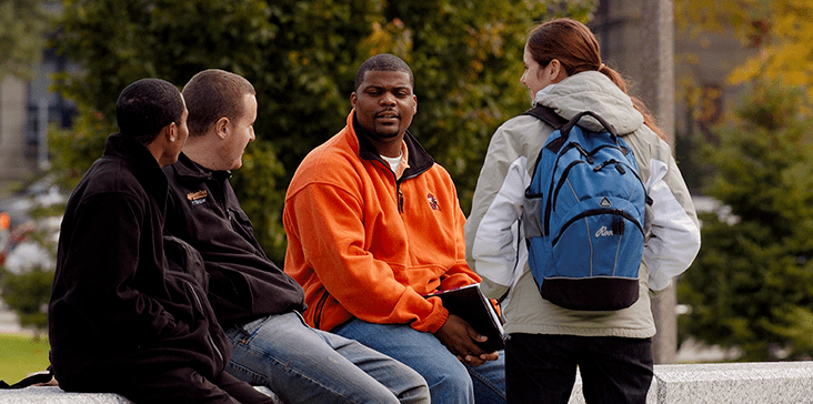 Group of students having a conversation outside on MSU campus.