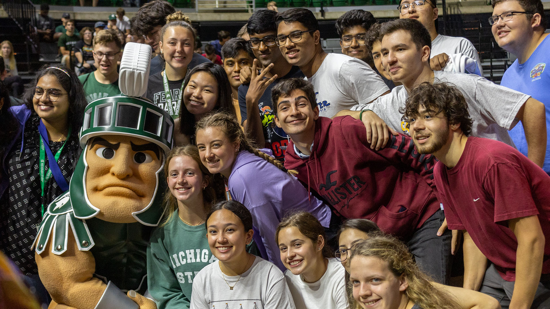 A group of students getting a photo with Sparty