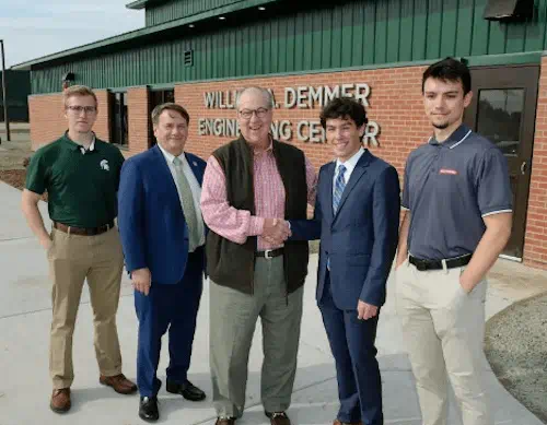 Nathan Oberer, Dean Leo Kempel, William Demmer, Riley Lawson,and Kyle Neid stand in front of the new William A. Demmer Engineering Center.