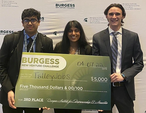 Photo of Maddur and his group holding an award plaque