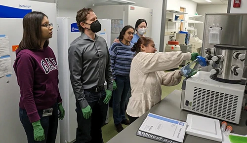 Photo of professor and students in a lab