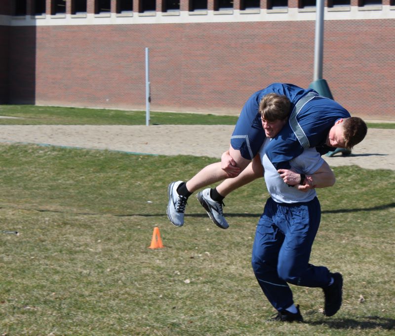 Matthew Bush is seen here carrying fellow cadet Talis Fricsons during an MSU Air Force ROTC training exercise on campus.