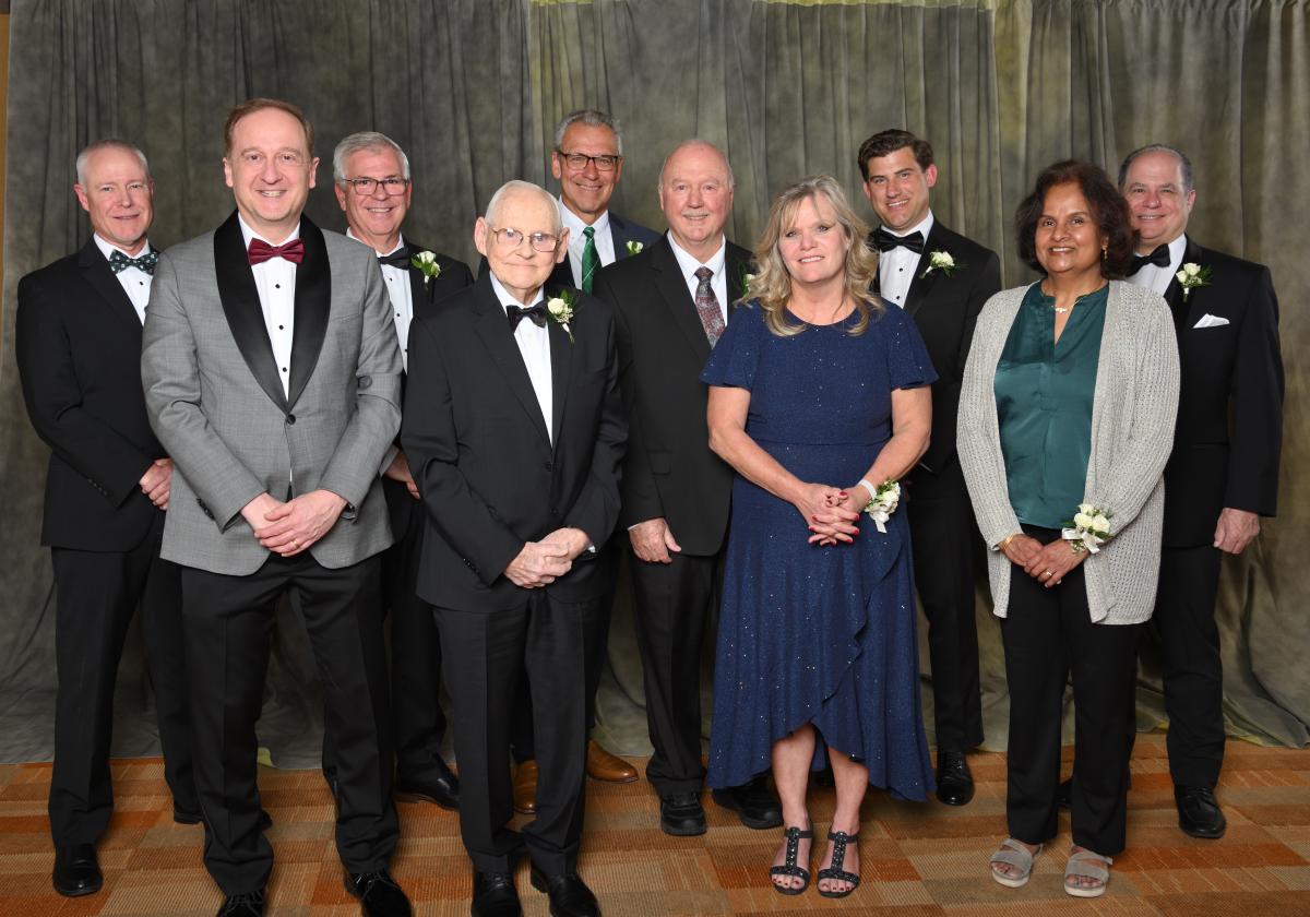 Group photo of the 2025 Alumni Award recipients standing together at the ceremony, smiling and holding their awards.