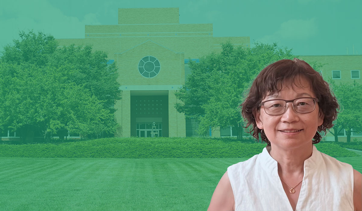 Biomedical Engineering Chair, Cheri Deng, with glasses, wearing a white shirt, and smiling at the camera
