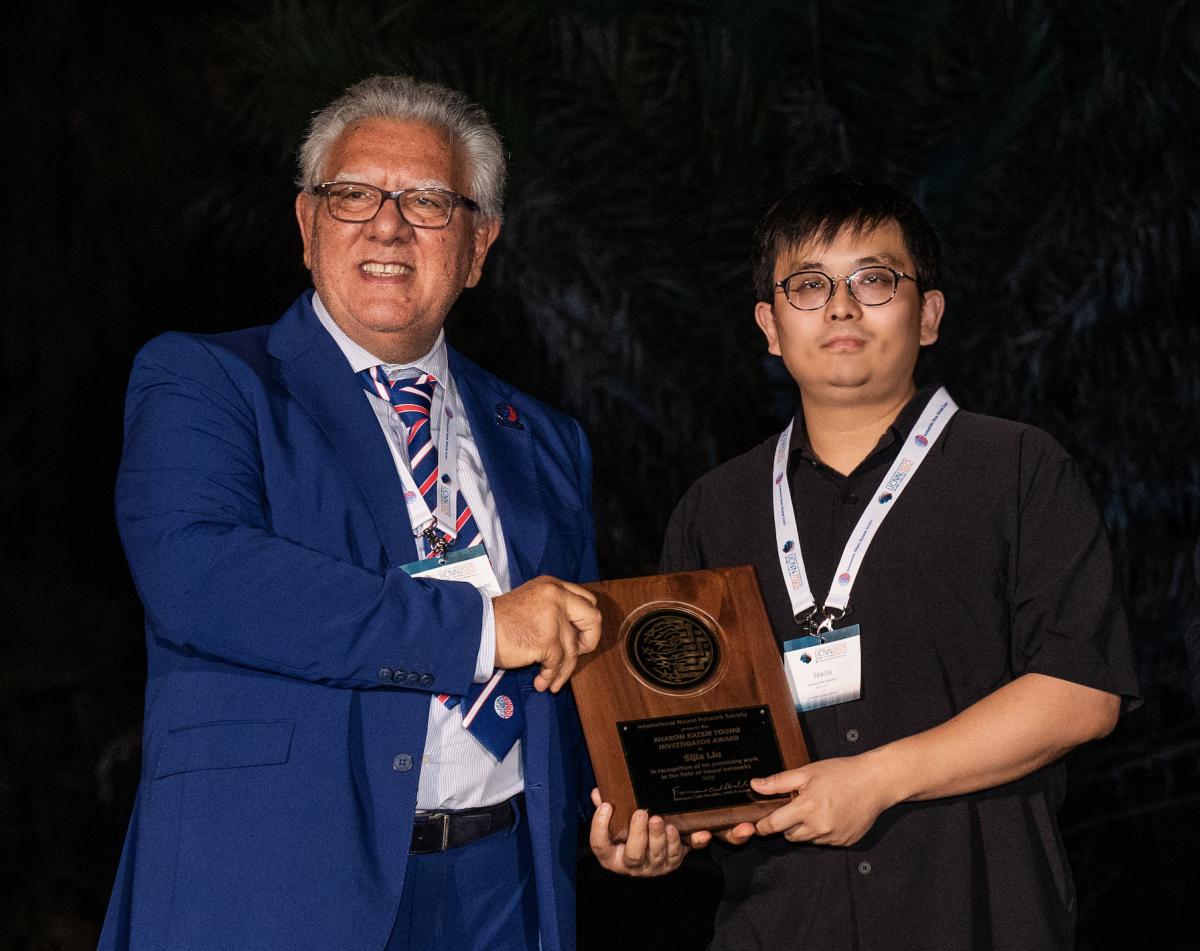 Sijia Liu (right) receives Young Investigator Award from official of the International Neural Network Society.