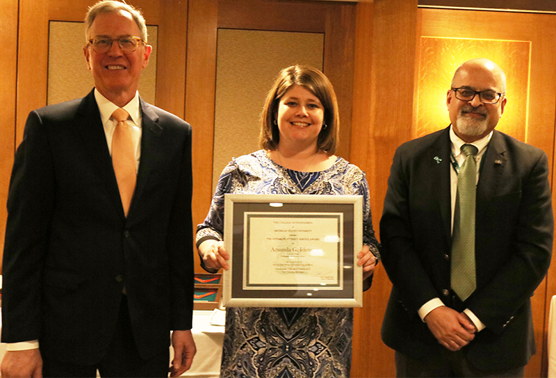 Amanda Idema, assistant dean for Undergraduate Student Affairs, was recognized for her outstanding service to students. Associate Deans Tom Voice (left) and Neeraj Buch made the presentation.