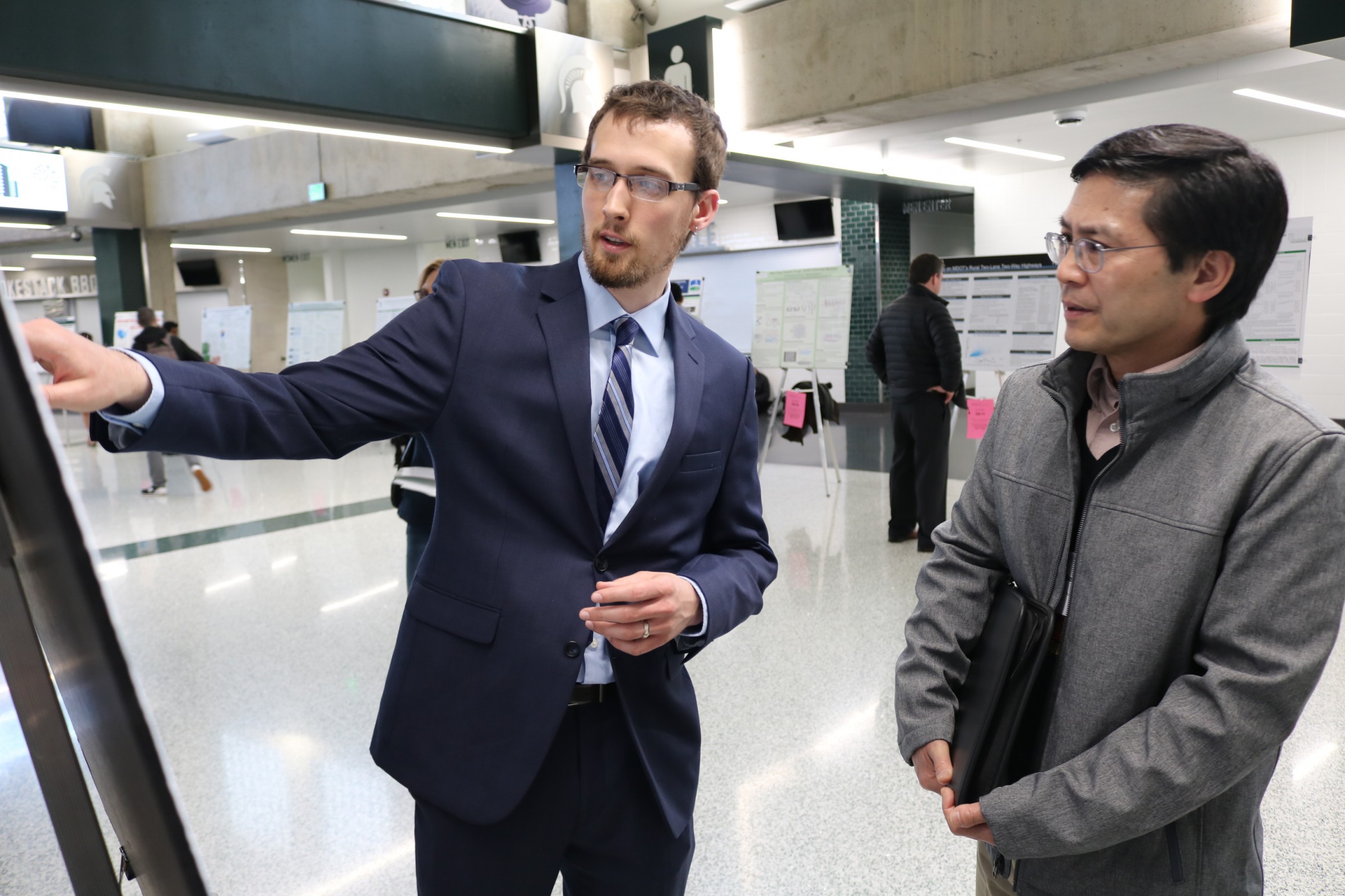 William Jensen, a PhD student in electrical and computer engineering, was among the almost 300 graduate students with poster presentations. He explains his work on reliability and performance of electrical machines to Biosystems Engineering Adjunct Professor Renfu Lu, among the many faculty members who supported the students in 2018.