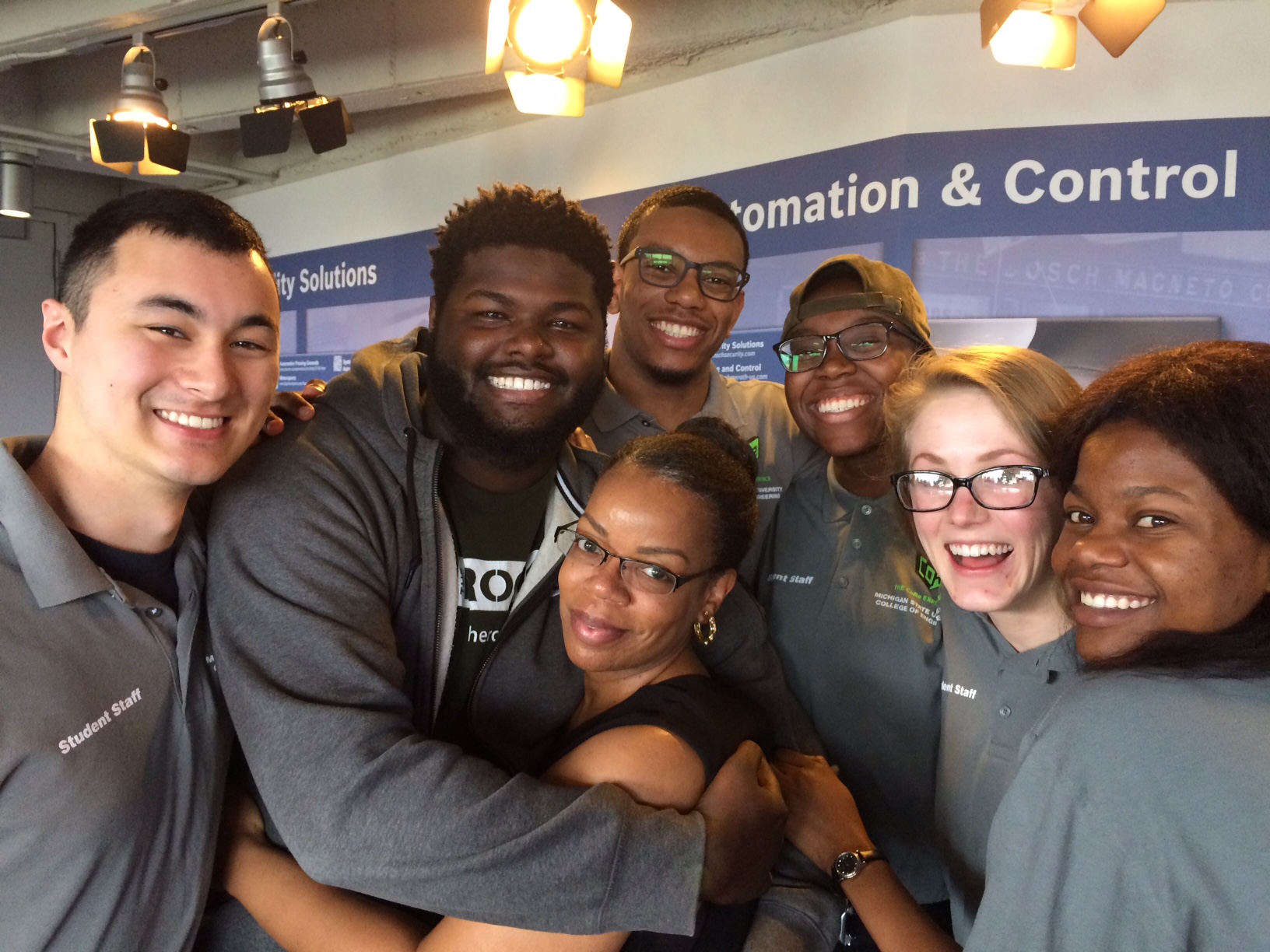CoRe co-curricular director Carmellia Davis-King (center) gets a group hug from CoRe students and leaders.