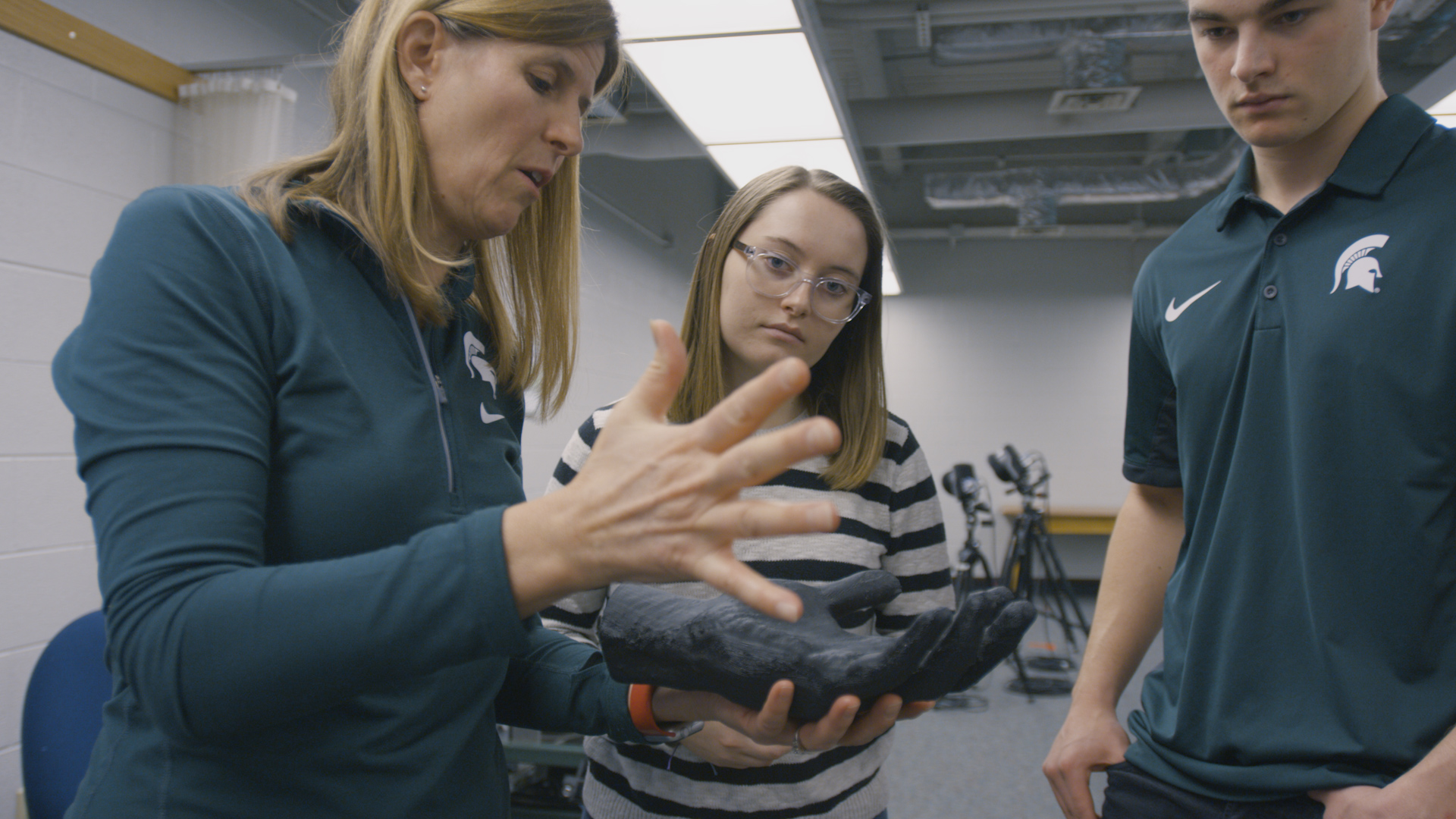 Mechanical engineer Tamara Reid Bush holds the 3D model of Nick Ward's left hand. She said her students related to the engineering challenge and solution.