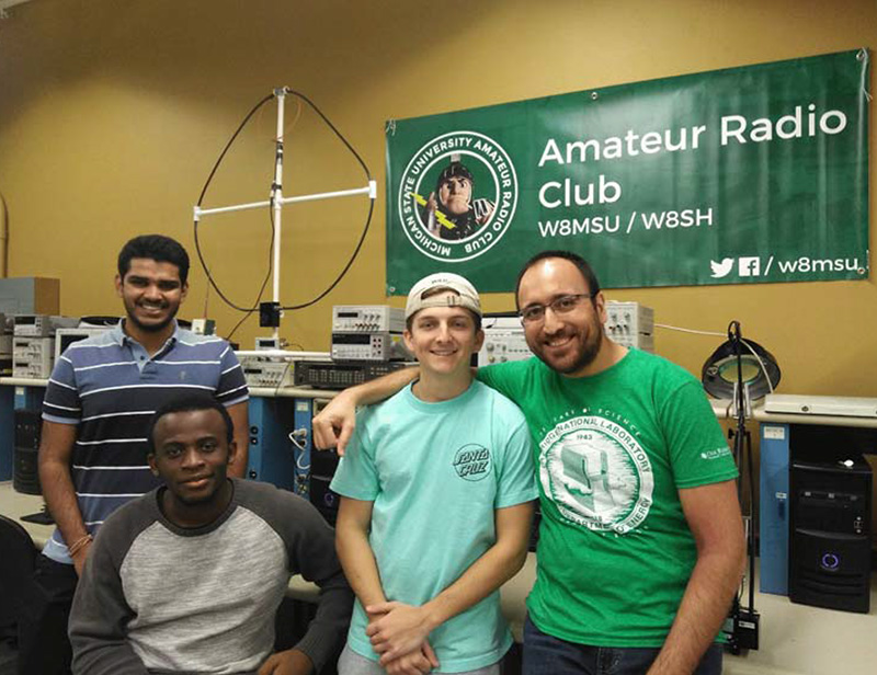 Helping MSU's Amateur Radio Club celebrate its 100th anniversary are Varun Venkatrao (KE8LKD), Nicolau Esteves (KE8LKE), Stephen Pietras (KE8LAK), and Volkan Yildirim (KE8KYB).