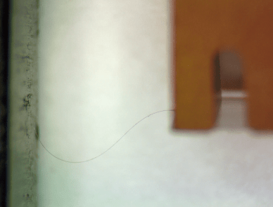 A diamond fiber looks like a wavy strand of hair, showing off its flexibility and small size. Courtesy of Wen Li.