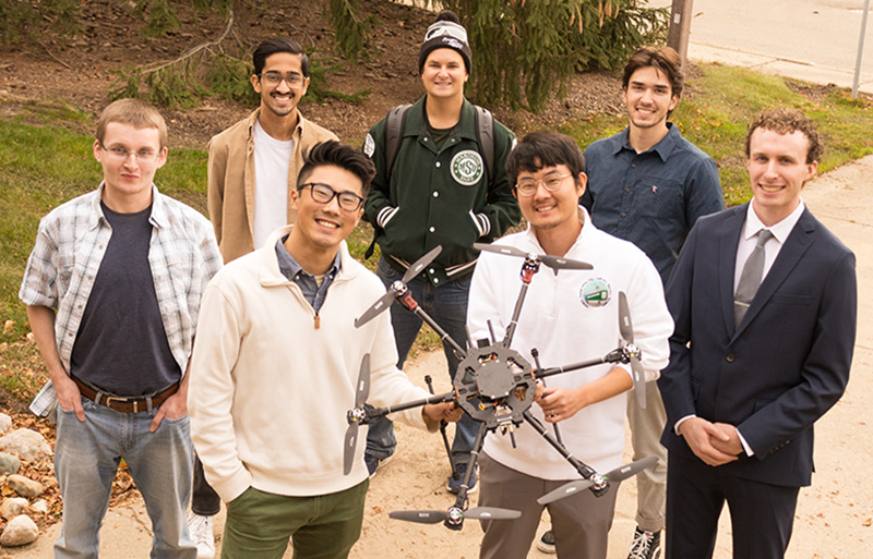 Yuchen Wang and Woongkul Lee and (back) Kindred Griffis, Rohan Singh, Ryan Koschay, Ross Davis, and Gavin Gardner are advancing their NASA drone project.