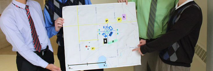 MSU college of engineering students showcasing a poster of one of their projects