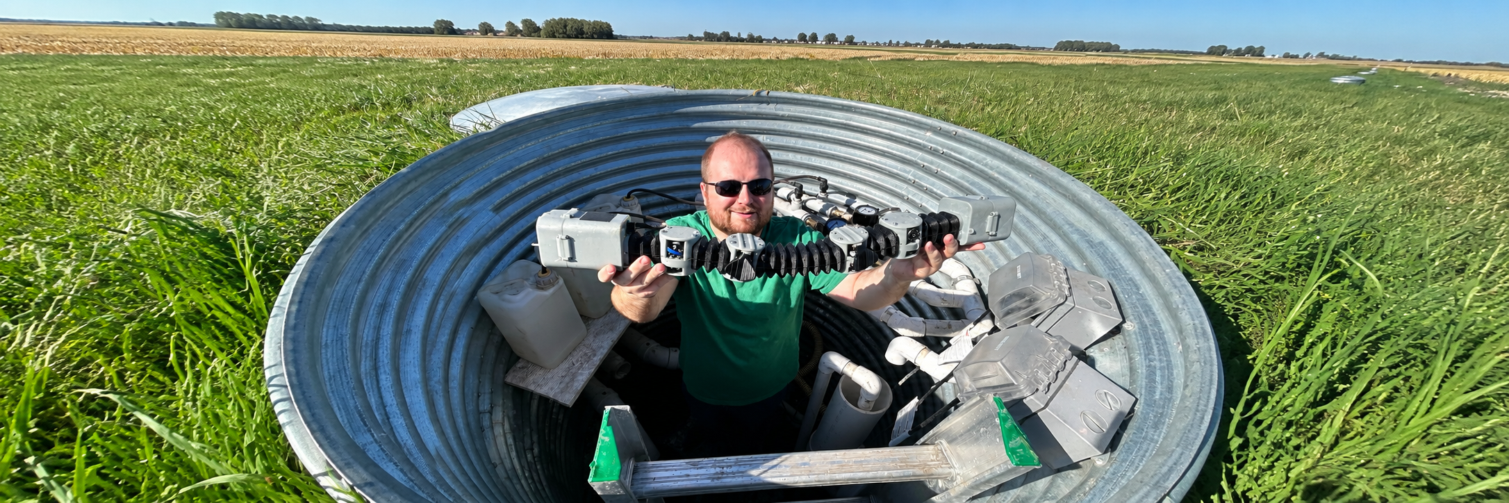 Researcher holding robot in drainage pipe