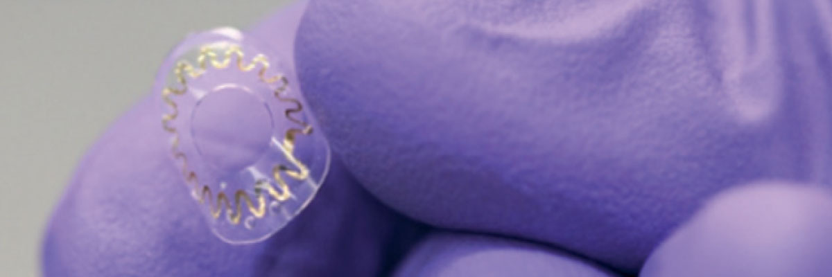 Gloved hand holding contact lens