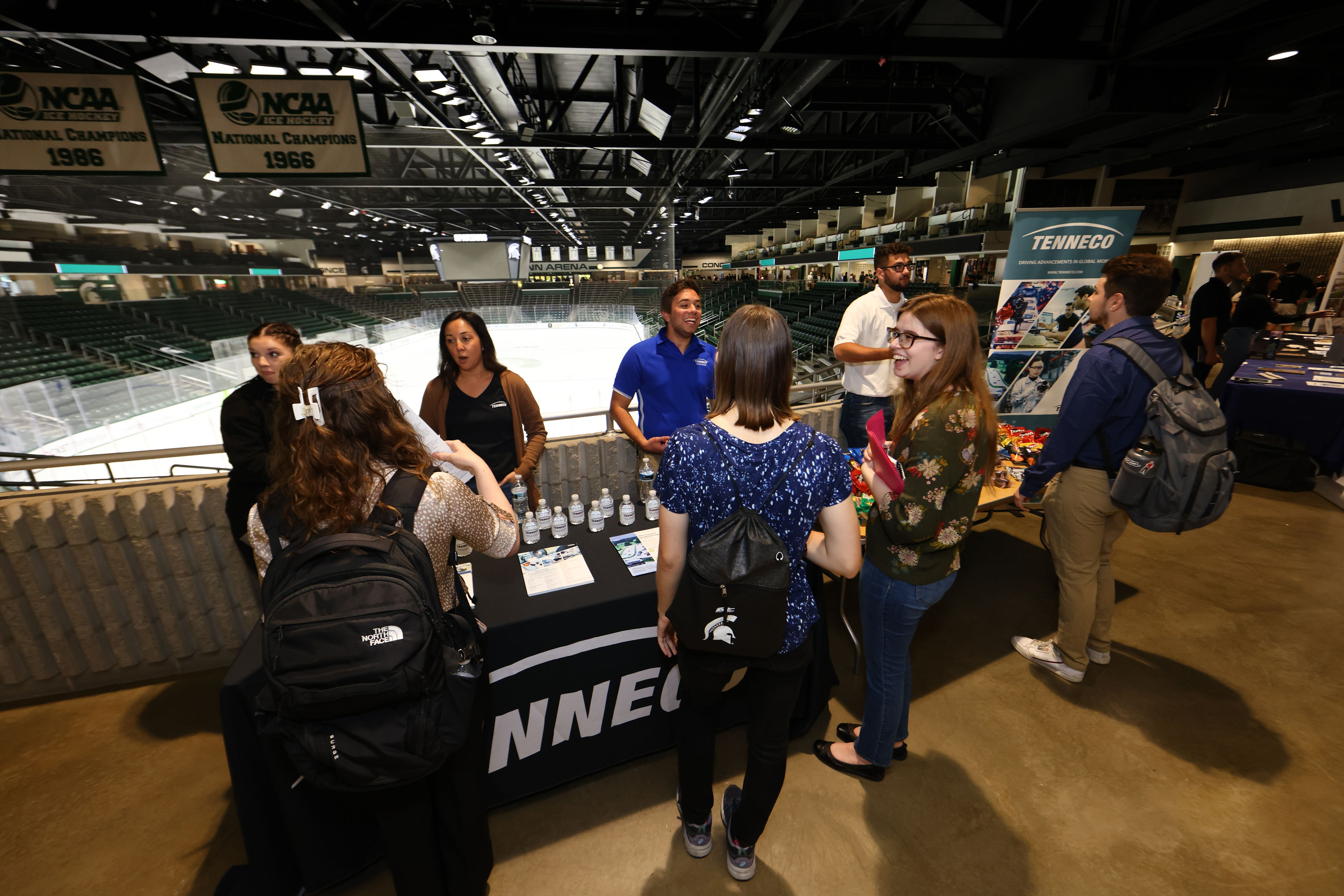Students interacting with employers at a booth