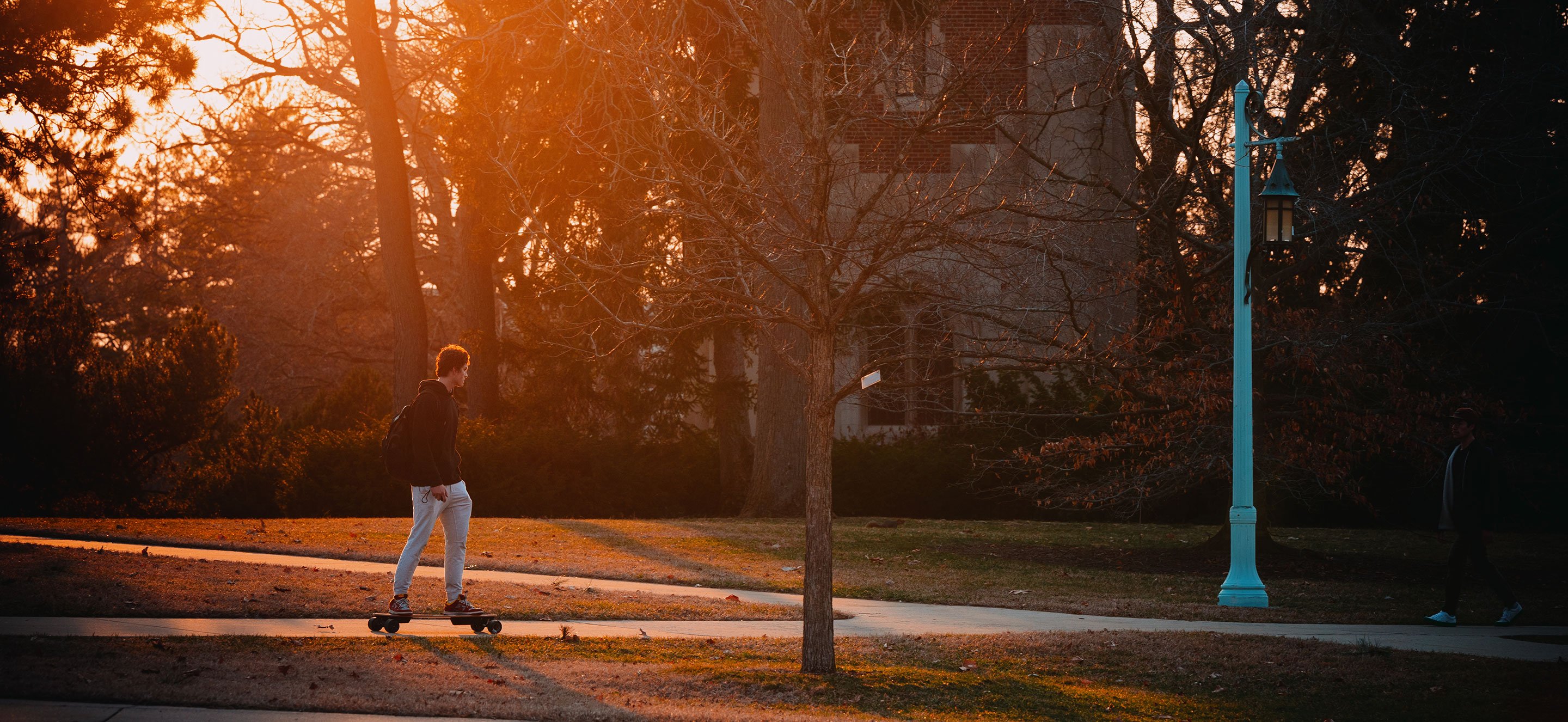 Student riding an electric skateboard