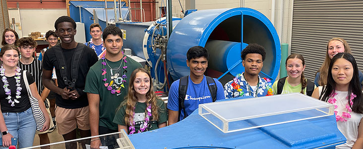 Students in front of a blue machine