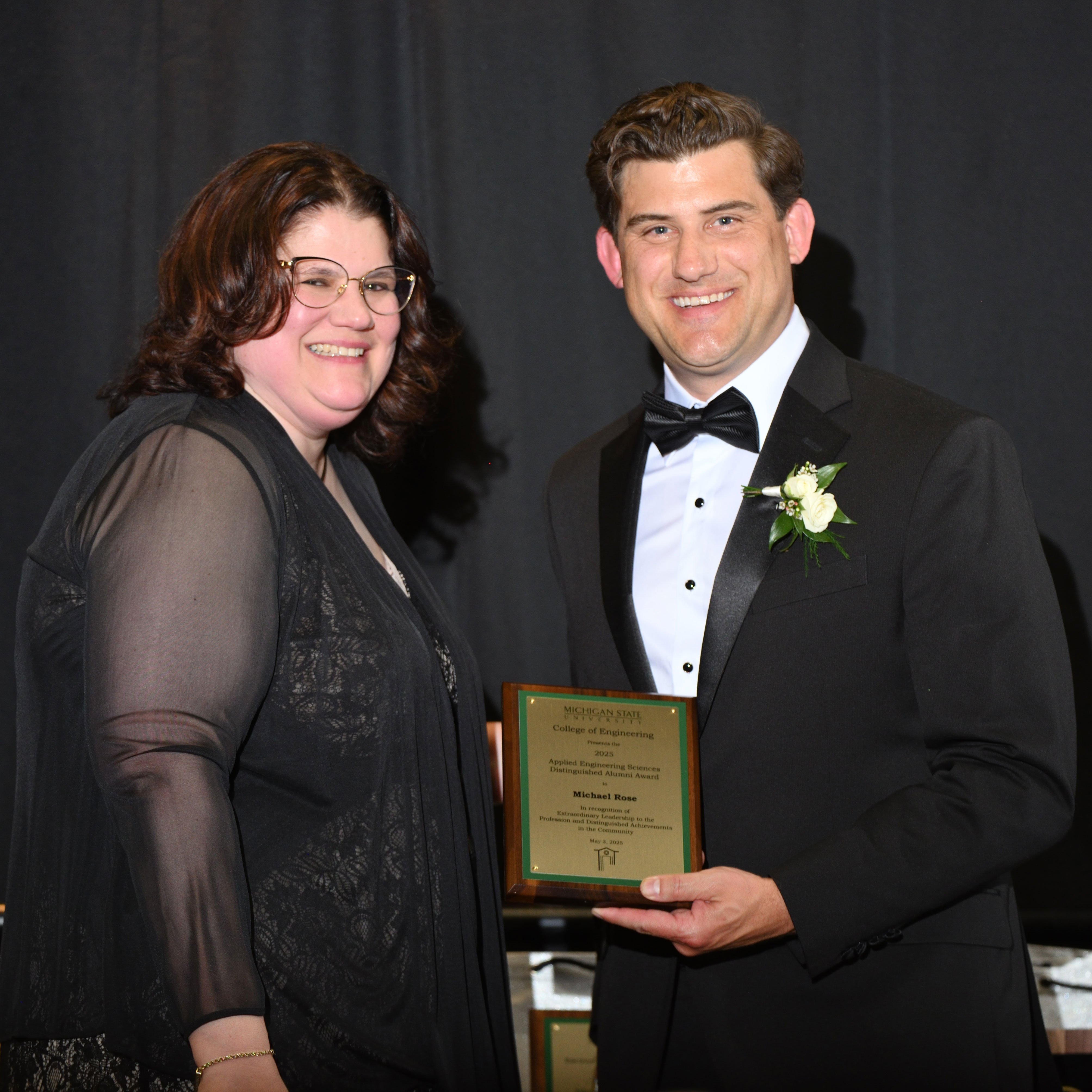 Laura Genik and Michael Rose posing with the award