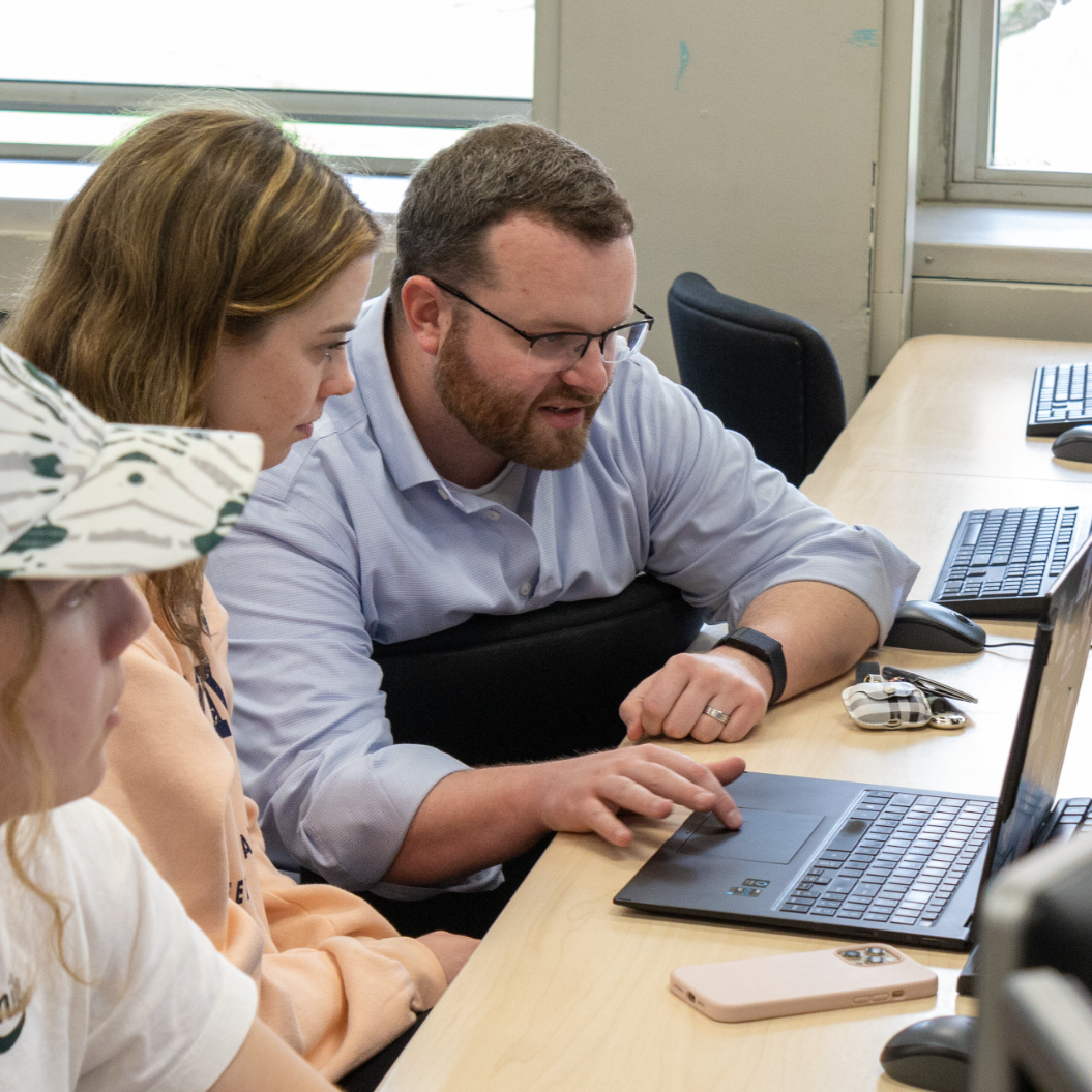 Person instructing students in a computer lab