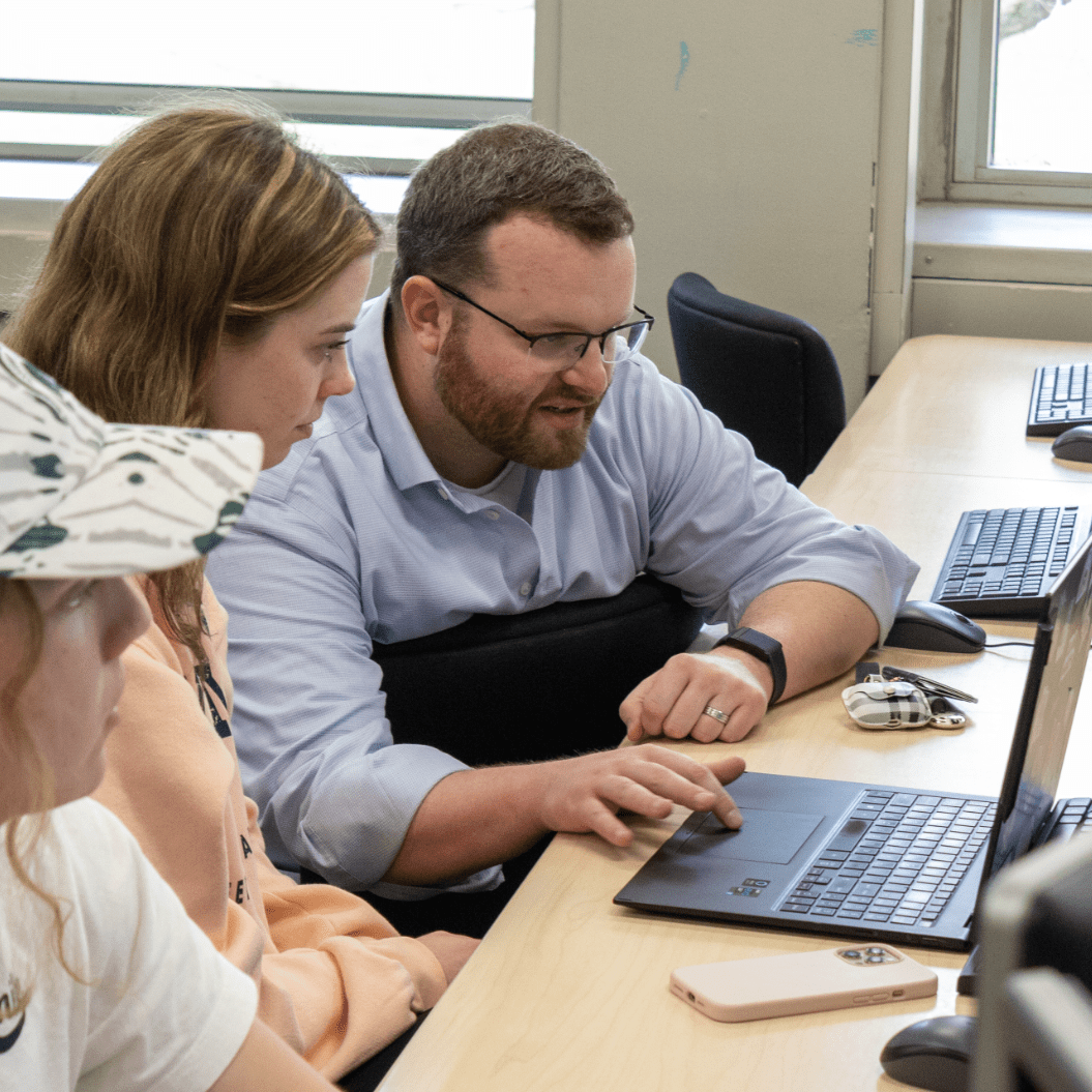 Person instructing students in a computer lab