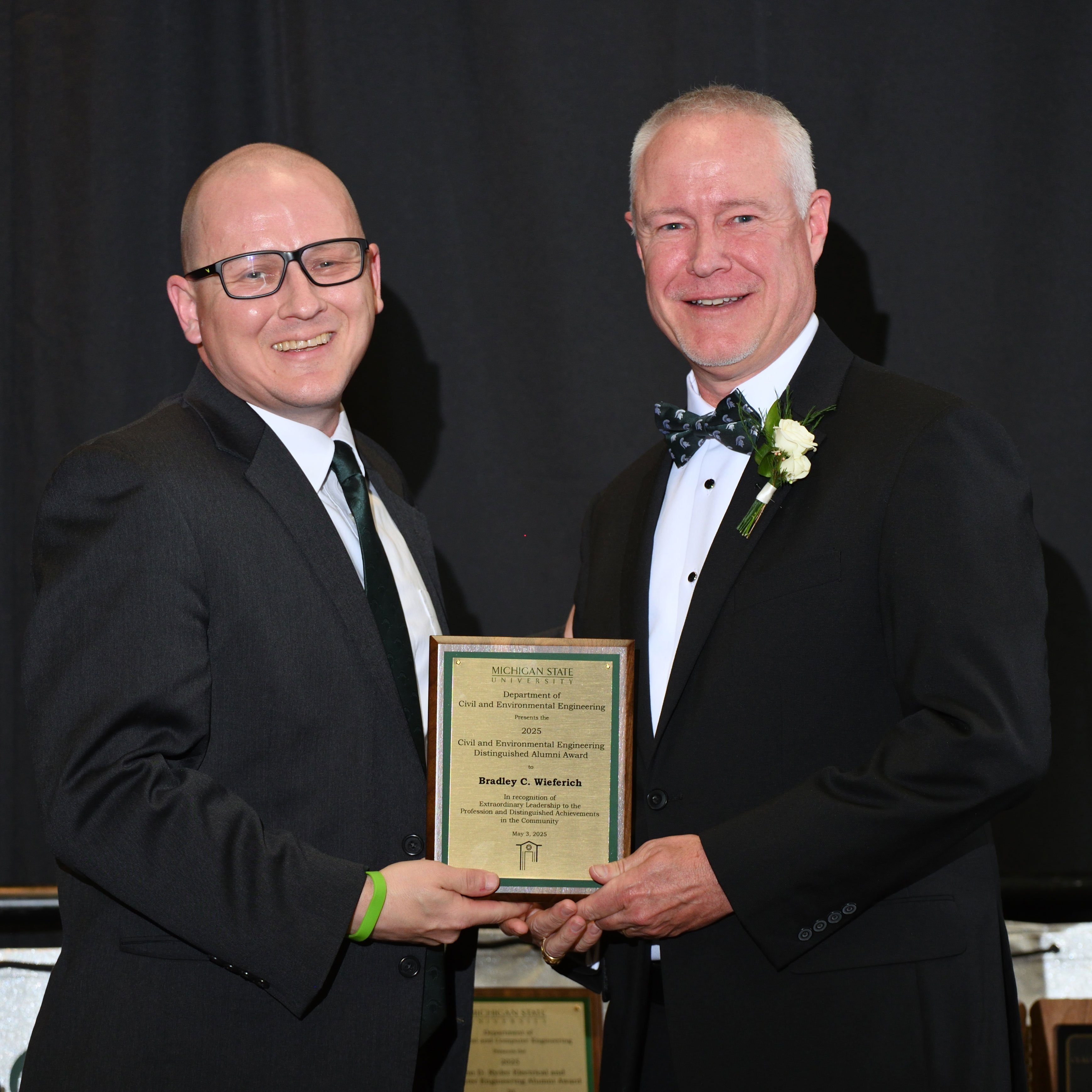 Pete Savolainen and Bradley C. Wieferich posing with the award