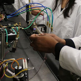 Students in lab coats handling equipment