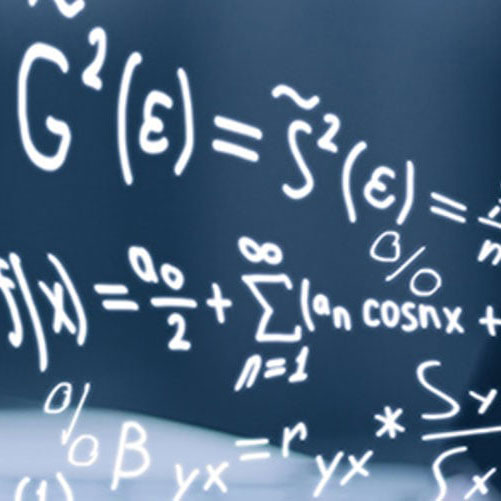Close-up of equations on a glossy chalk board