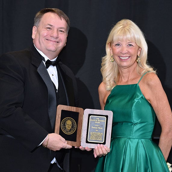 Donna Haye next to Dean Leo Kempel holding her award
