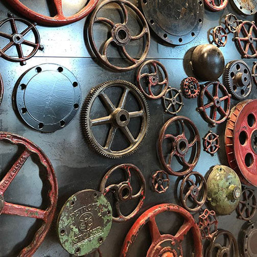 Variety of gears displayed on a wall