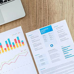 Close-up of a resume and laptop