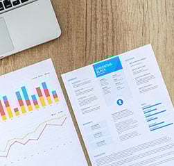 Close-up of a resume and laptop