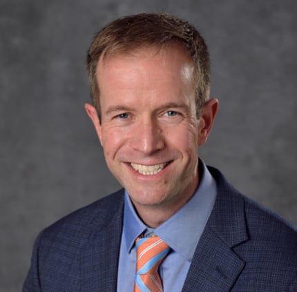 Professional headshot of Adam Alessio