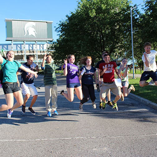 K-12 students jumping in the air