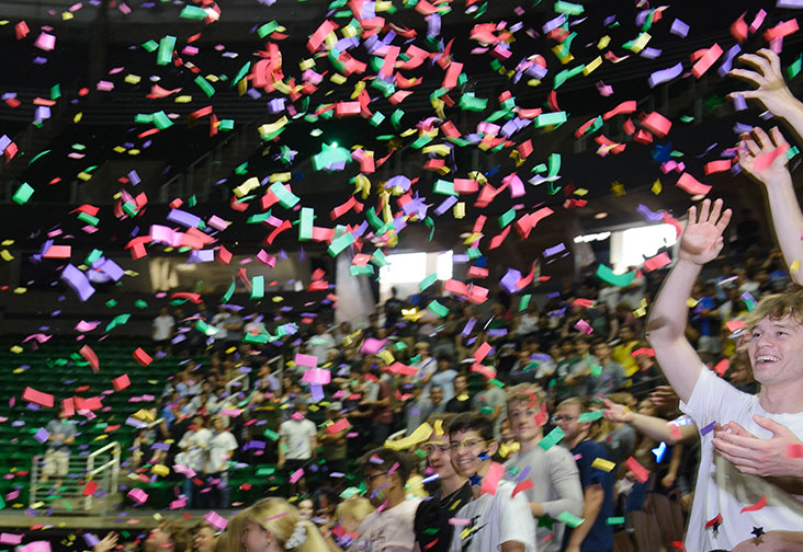 At the Breslin Stadium, first-year students attend the Engineering Colloquium. Confetti fills the air as the students smile and reach for it, celebrating the beginning of their engineering journey at Michigan State University