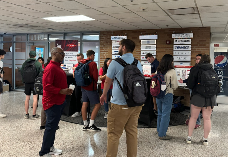 People talking to multiple companies in the lobby of the engineering building