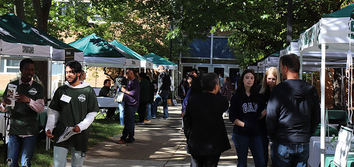Tents set-up in the Engineering Courtyard with students interacting with people