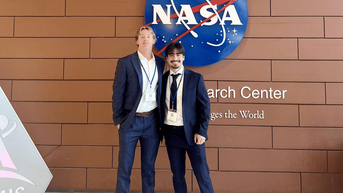 Two MSU Engineering students stand in front of a NASA sign at NASA Langley Research Center.