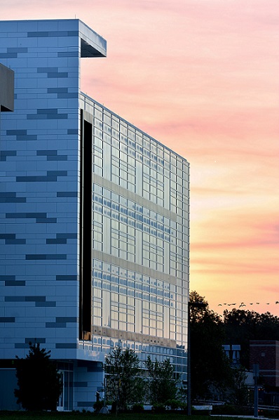 Close up of the BME IQ building with a sunset in the distance