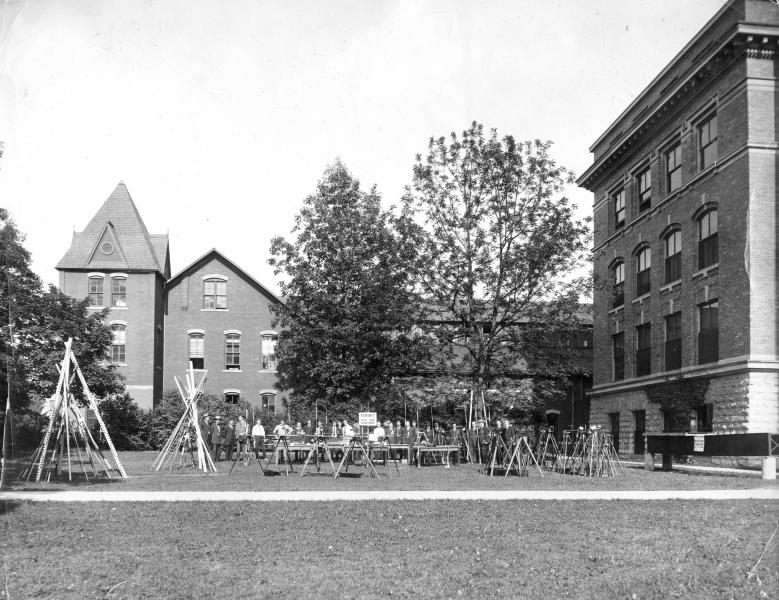 Black and White of the MSU Engineering with survey equipment placed in the front