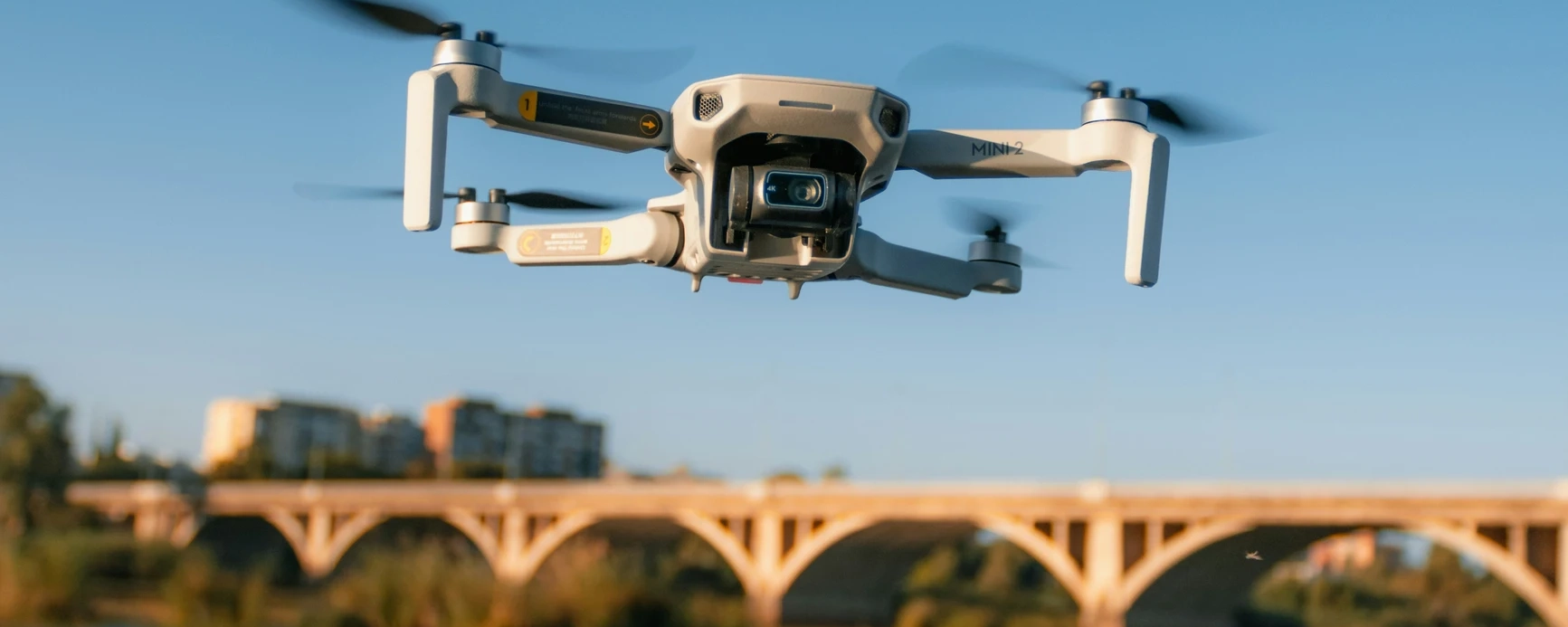 Drone flying near a bridge