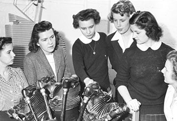 Group of students looking at machinery
