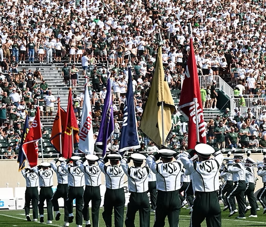 Marching band holding BIG 10 flags in Spartan Stadium