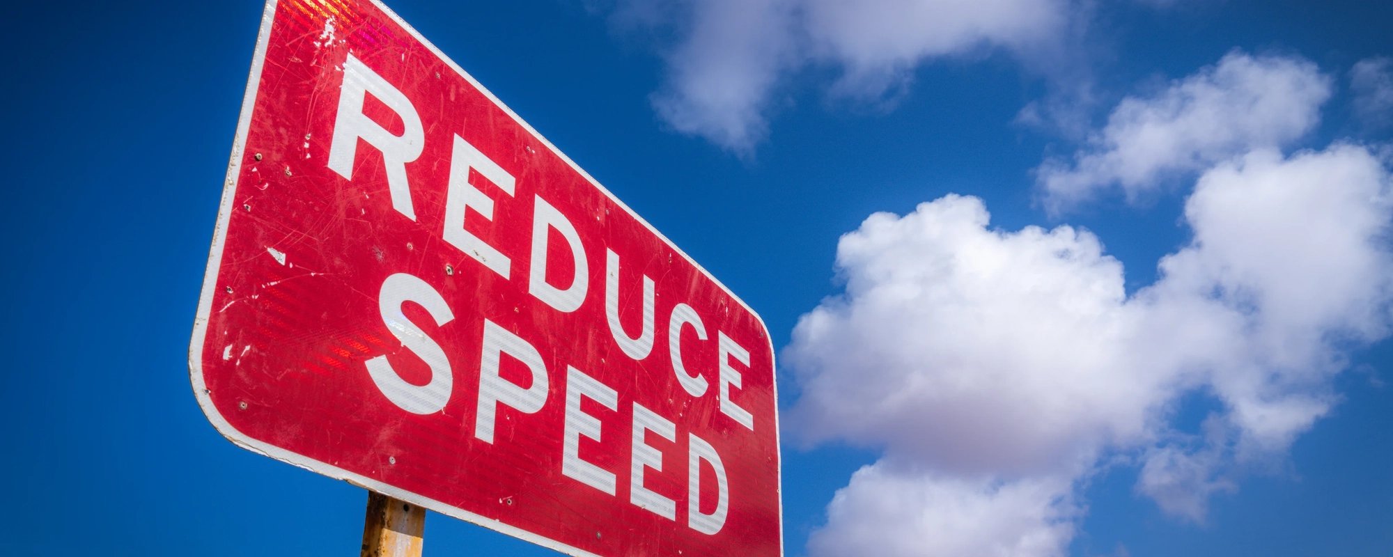 Reduce speed sign